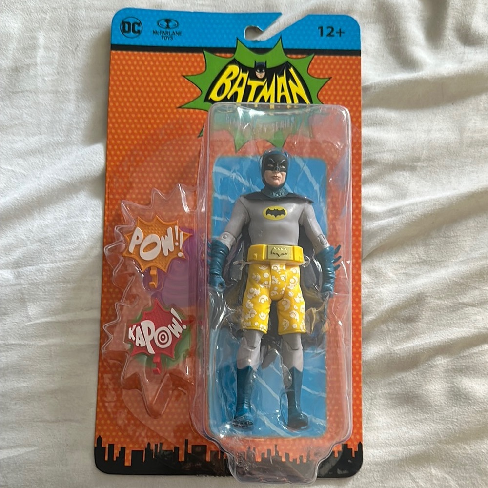 DC Batman Figure with Yellow Shorts and Comic Effects